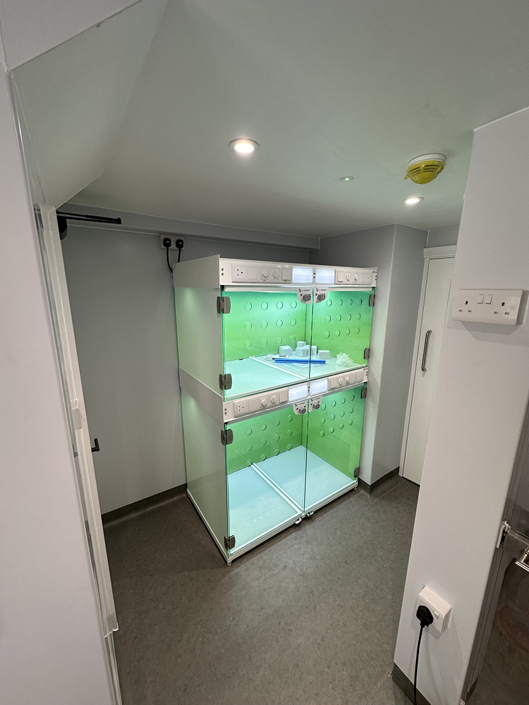 Glass-fronted animal recovery kennel unit installed in a veterinary practice