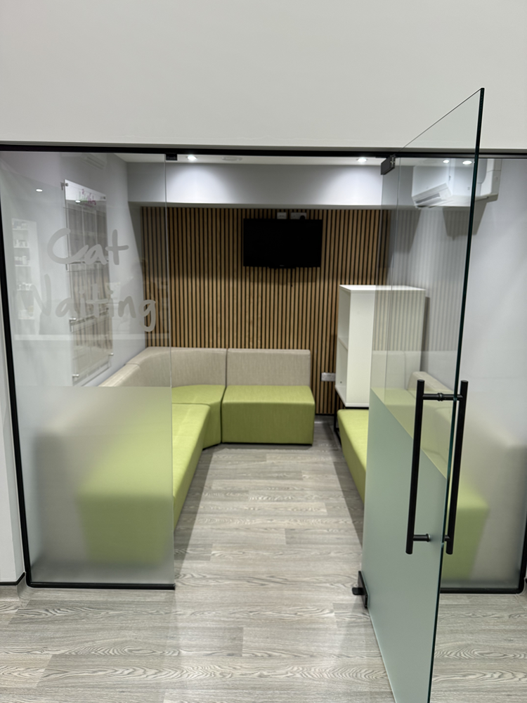 Cat waiting area fit-out with glass partition, seating and timber slat wall
