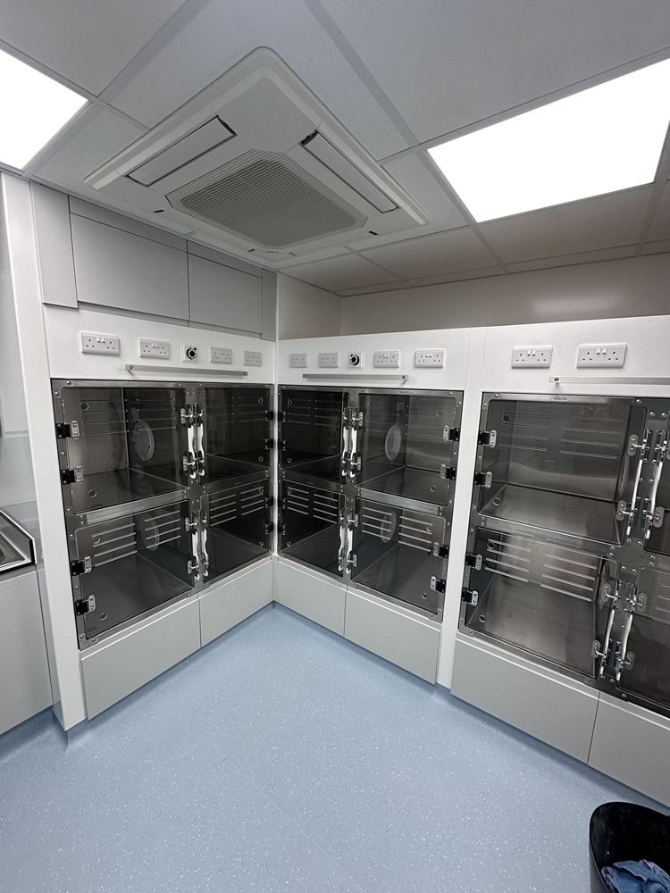 Bank of stainless steel dog kennels with hygienic flooring in a veterinary ward