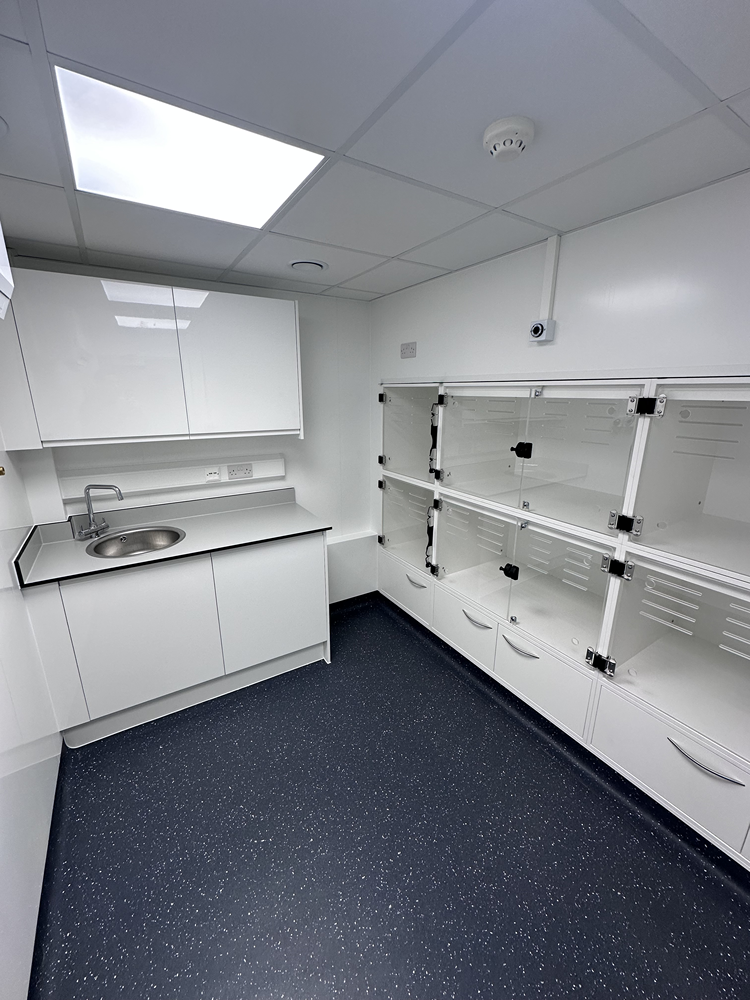 Veterinary laboratory fit-out with white benching, sink and storage