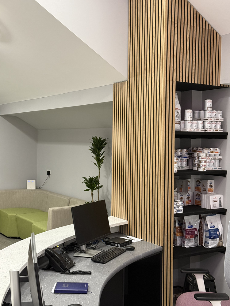 Retail display shelving and timber slats in a veterinary practice reception