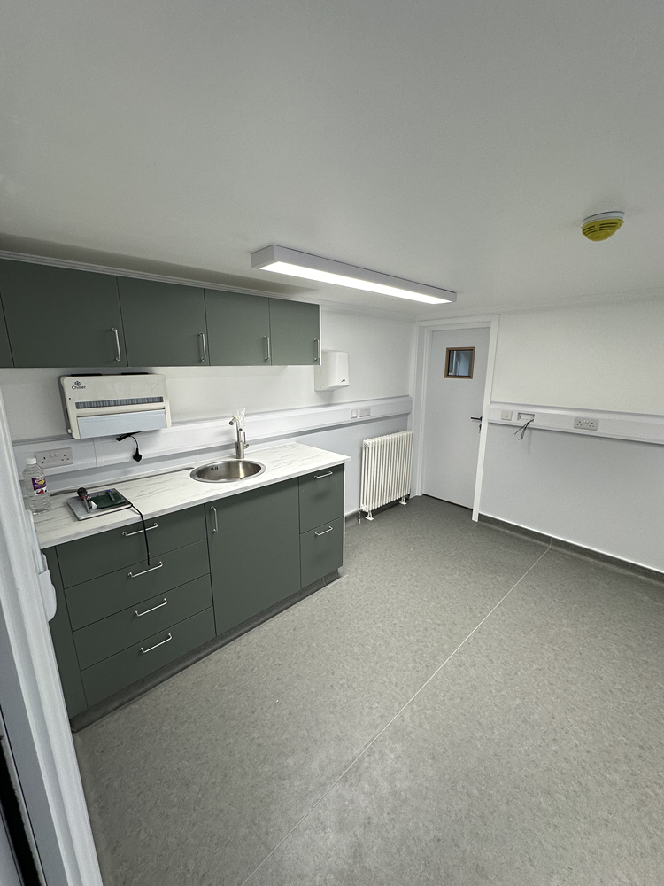 Veterinary prep room fit-out with fitted cabinetry, sink and hygienic vinyl flooring