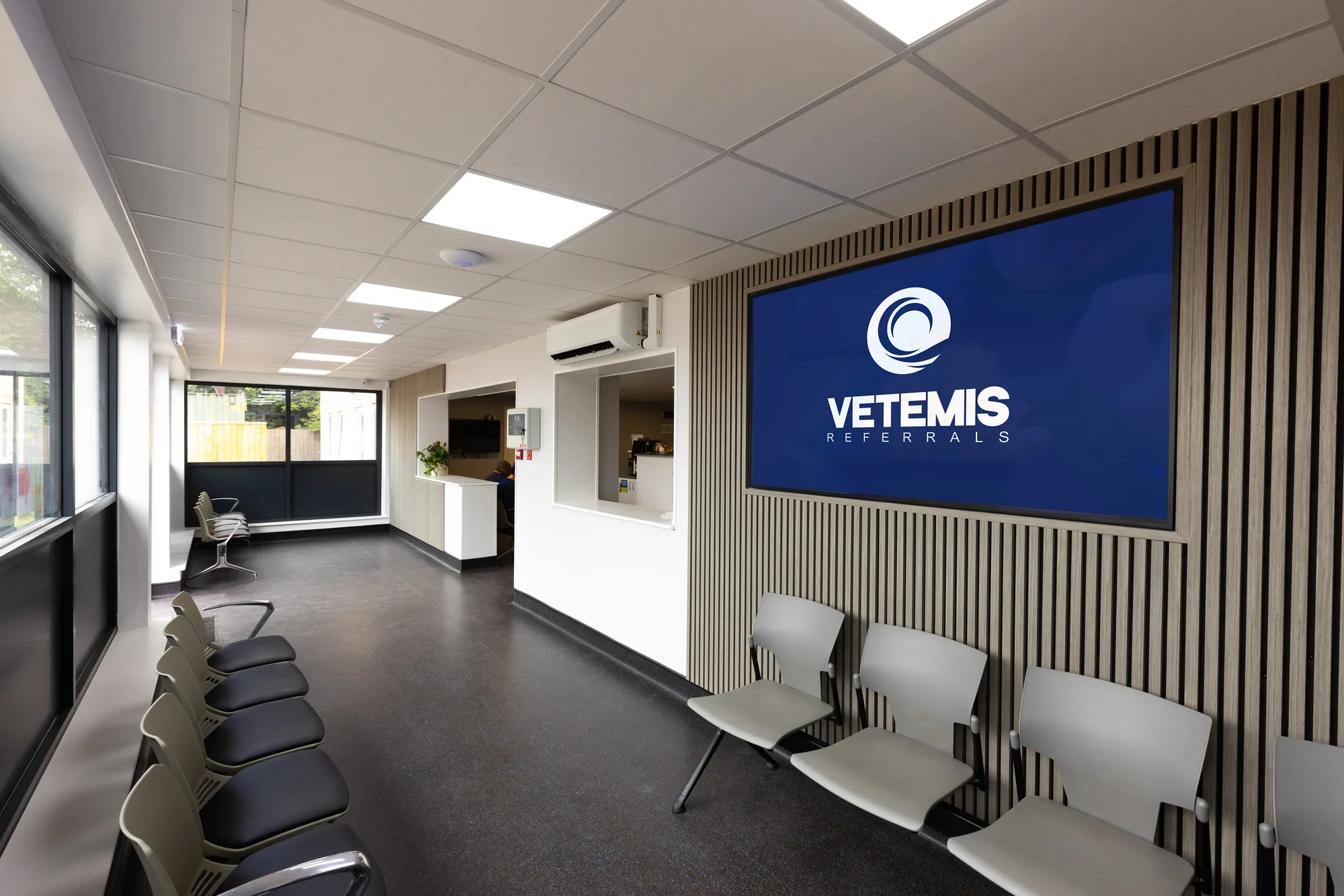 Reception and waiting area at Vetemis Referrals, Brownhills, with timber slat wall and seating