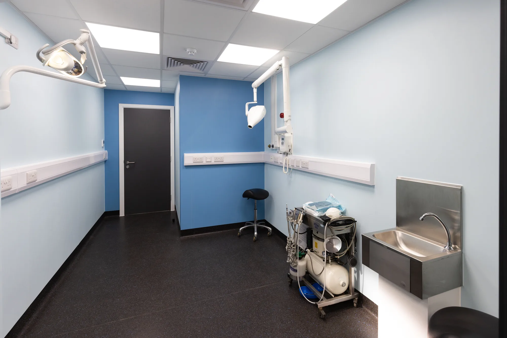 Treatment room at Vetemis Referrals, Brownhills, with examination light, clinical sink and wall-mounted equipment